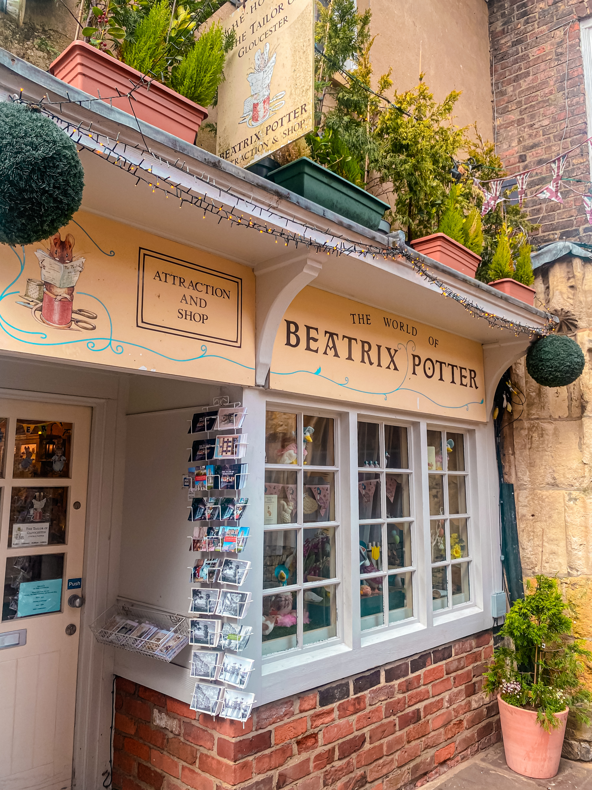 A gorgeous, quaint, yellow fronted shop with animal illustrations - the Beatrix Potter shop and museum in Gloucester!
